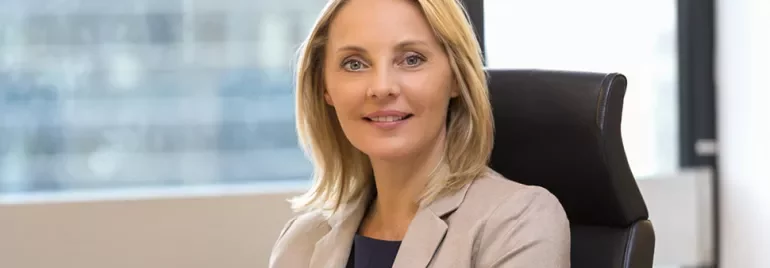 Person smiling while sitting in an office chair.